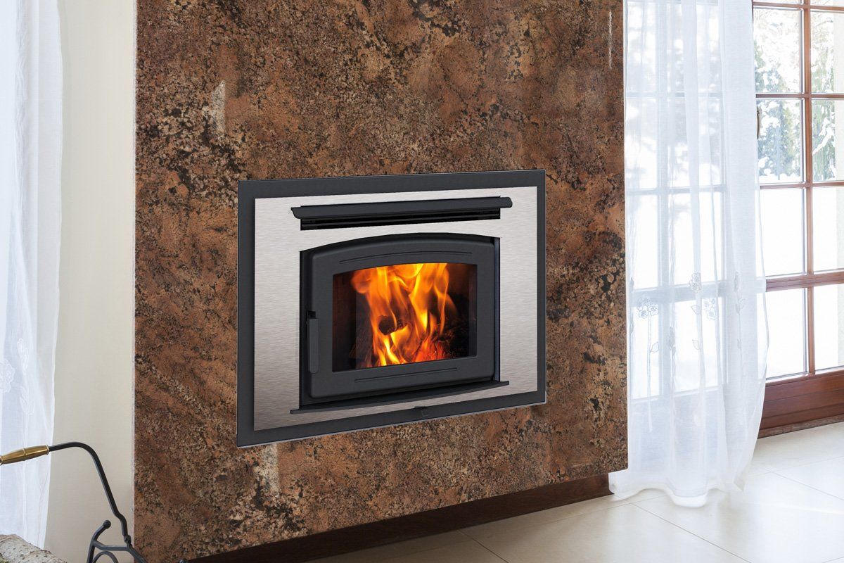 Fireplace inset in a brown stone wall, flames burning, stainless steel trim, near a window with sheer white curtains.