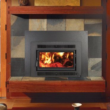 A fireplace with burning flames, set in a wooden and tiled surround.