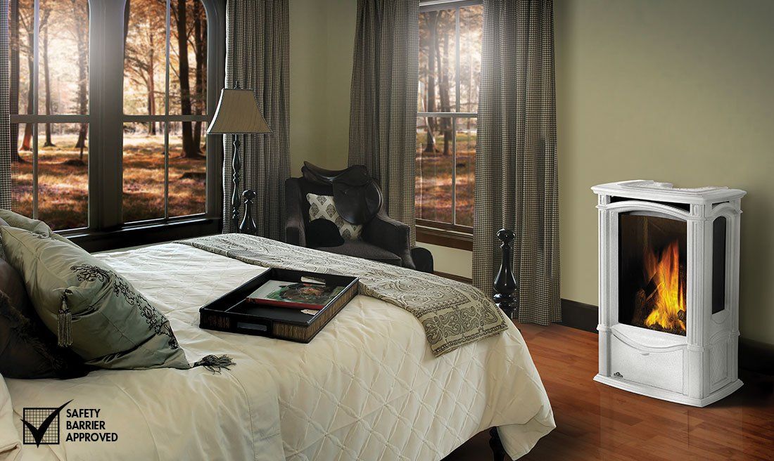 Bedroom with white bed, windows, and a white stove with a visible flame.