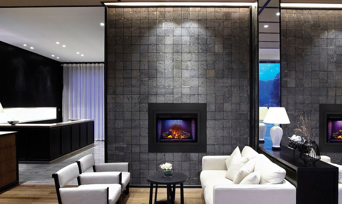 Cozy living room with fireplace on textured gray wall, white couches, black table.