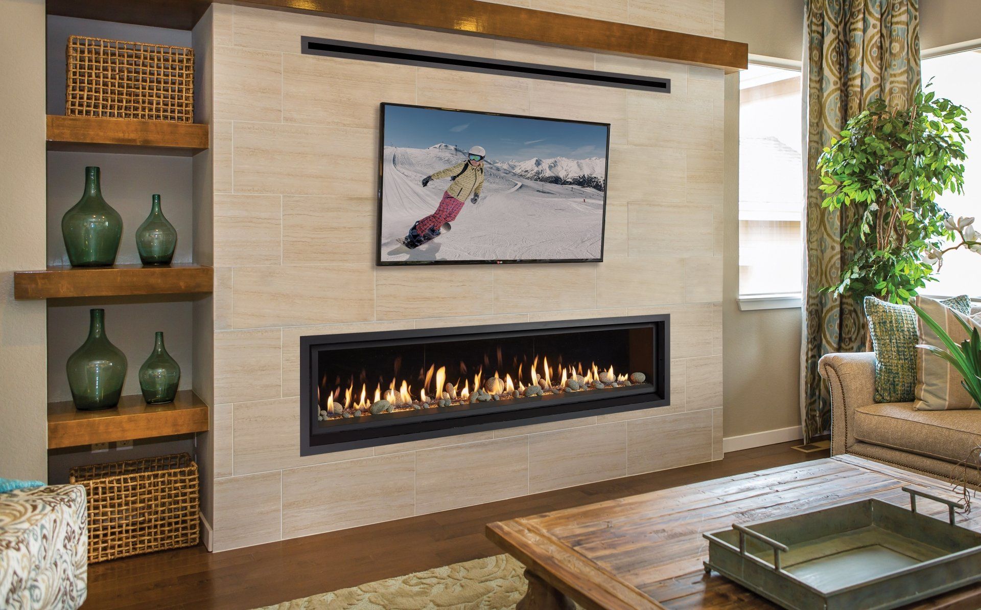 Living room with fireplace, TV, built-in shelving, and sofa; neutral tones.