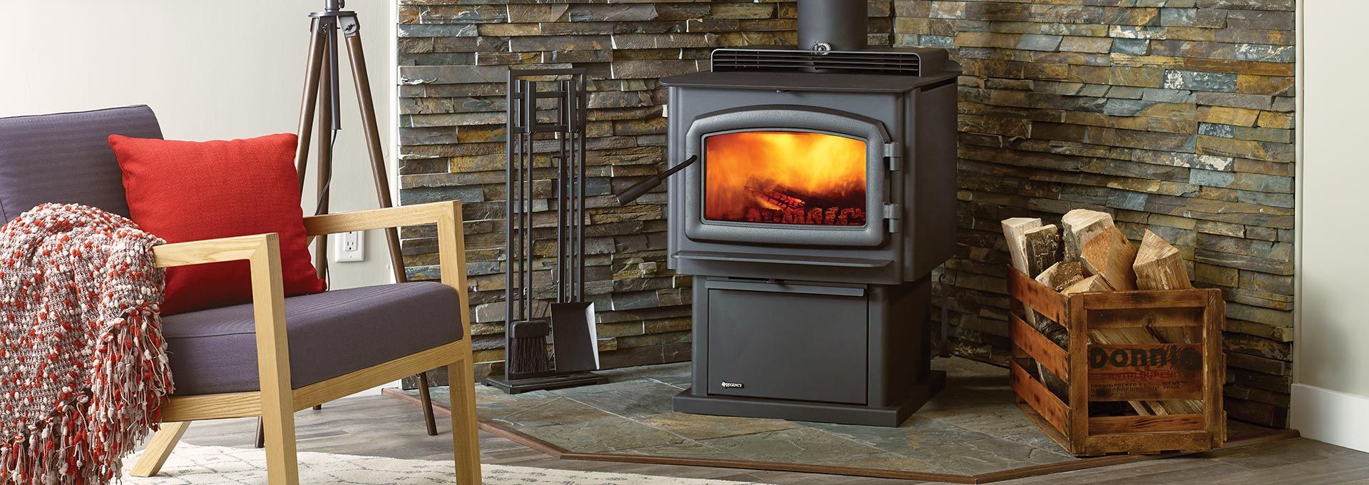 A cozy living room scene with a lit fireplace, armchair, and firewood crate.