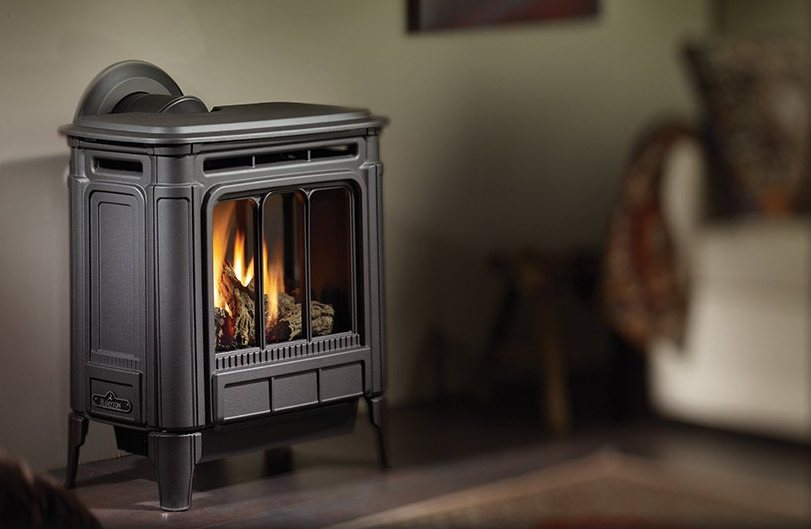 Black gas fireplace with flames, in a living room setting.
