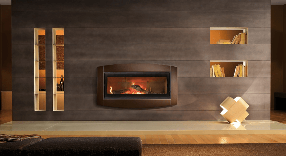 Modern fireplace embedded in a textured wall, flanked by shelving and lit niches.
