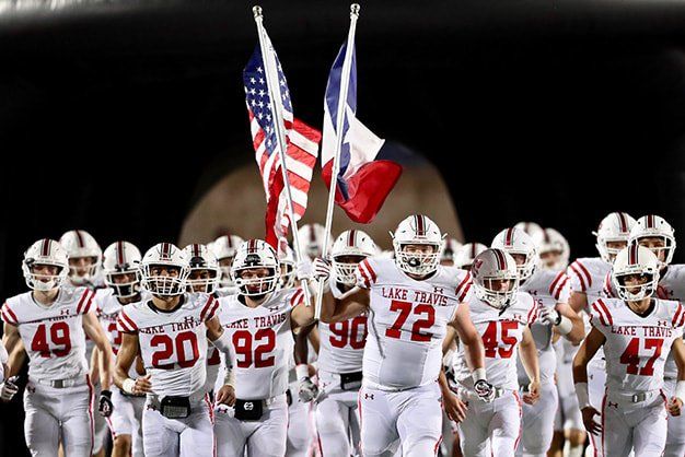 Lake travis football team running out of the tunnel