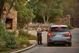 Security Guard Stopping Car at Gate