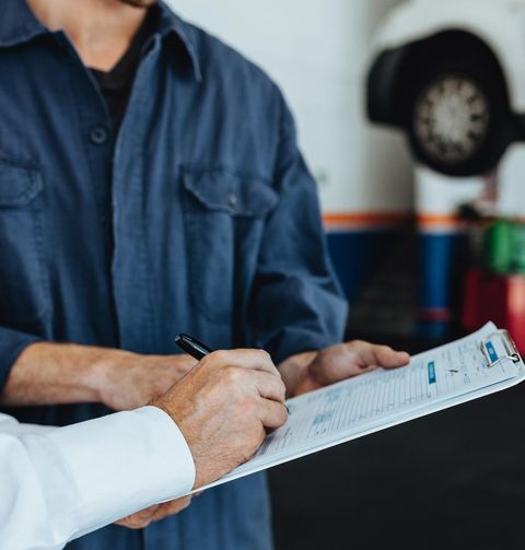 Auto Warranty — Signing Document on Auto Repair Shop in Springfield, IL Auto Warranty — Signing Document on Auto Repair Shop in Springfield, IL