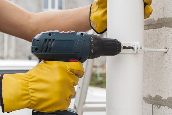 someone drilling the gutter pipe