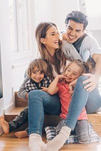 Family Laughing Together on Stairs