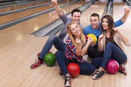 Friends Holding Bowling Balls - Bowling in Everett, WA