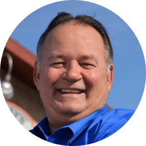 A man in a blue shirt is smiling in a circle