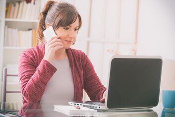 Women looking at her laptop — telephone support in Quincy, MA Women looking at her laptop — telephone support in Quincy, MA