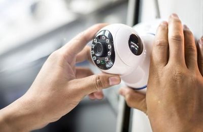 Hand Holding a CCTV — Essex Junction, VT — Sun Ray Fire & Security