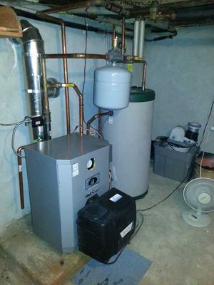 A room with a water heater and a fan
