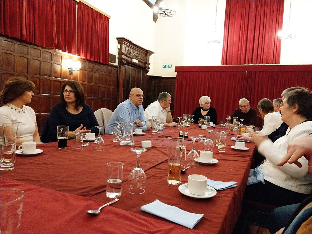 The members and their partners enjoy after dinner conversation with their coffees