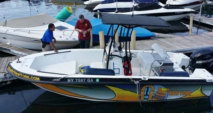 Two Man Checking the Colorful Boat — Mahopac, NY — Mahopac Marina