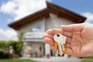 Close up of person holding house keys in their hand