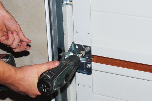 Garage Door Repair — Man Repairing the Garage Door in Spring Lake Park, MN