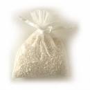 A bag of white rice is sitting on a white surface.