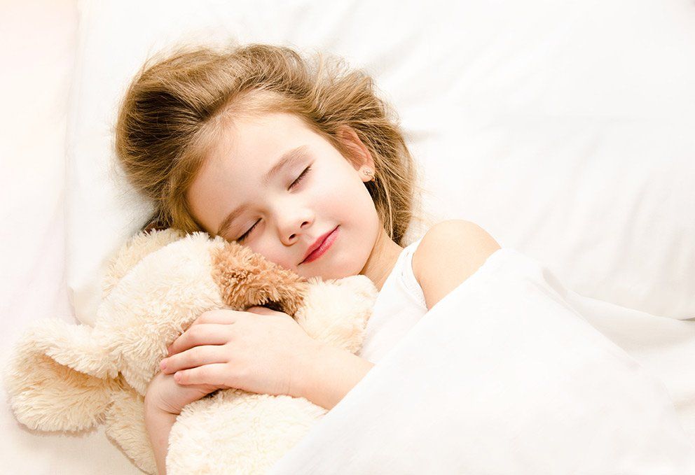 A child holding a teddy bear