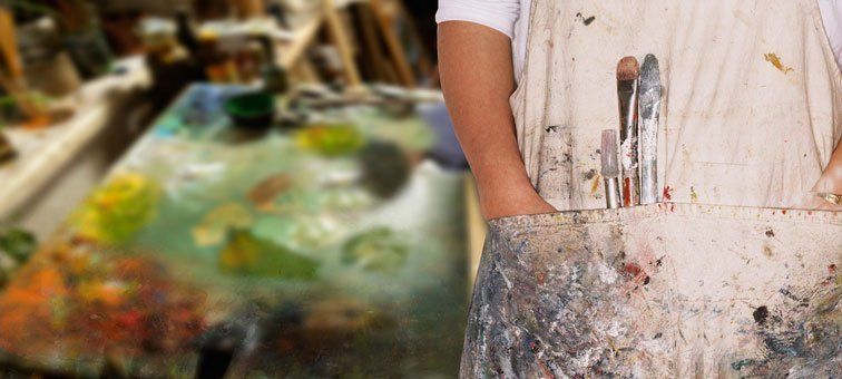 Painter with dirty coveralls on