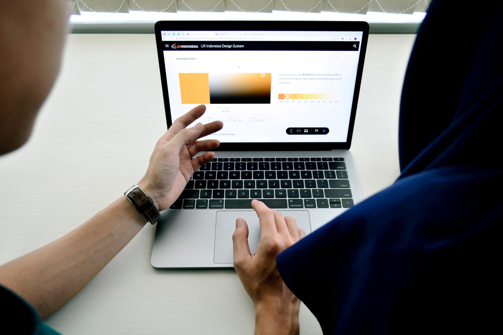 A person is typing on a laptop computer.