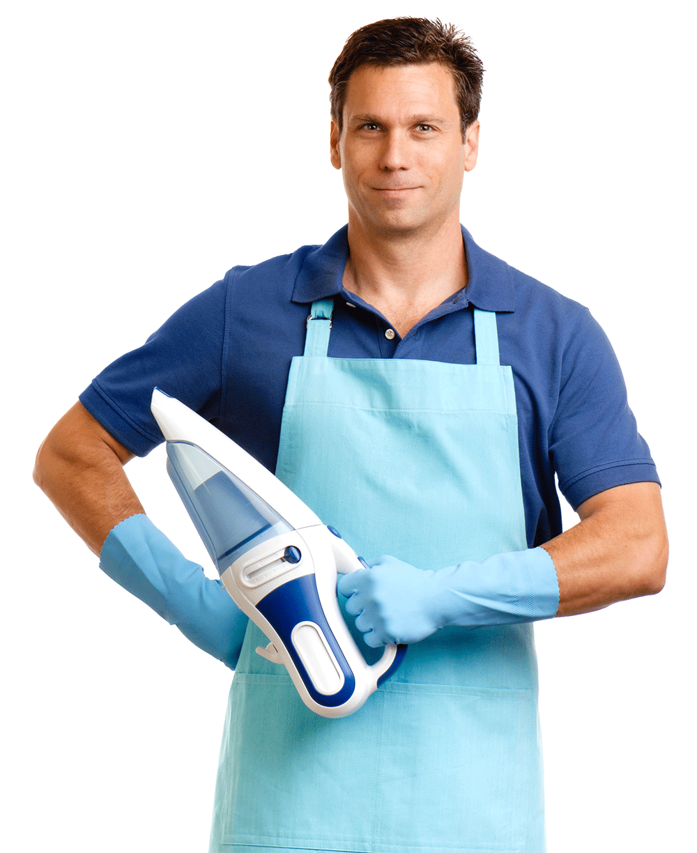 Man in blue shirt, apron, and gloves holding a handheld vacuum, smiling.