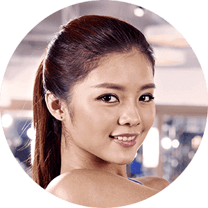 A woman in a ponytail is smiling in a circle.