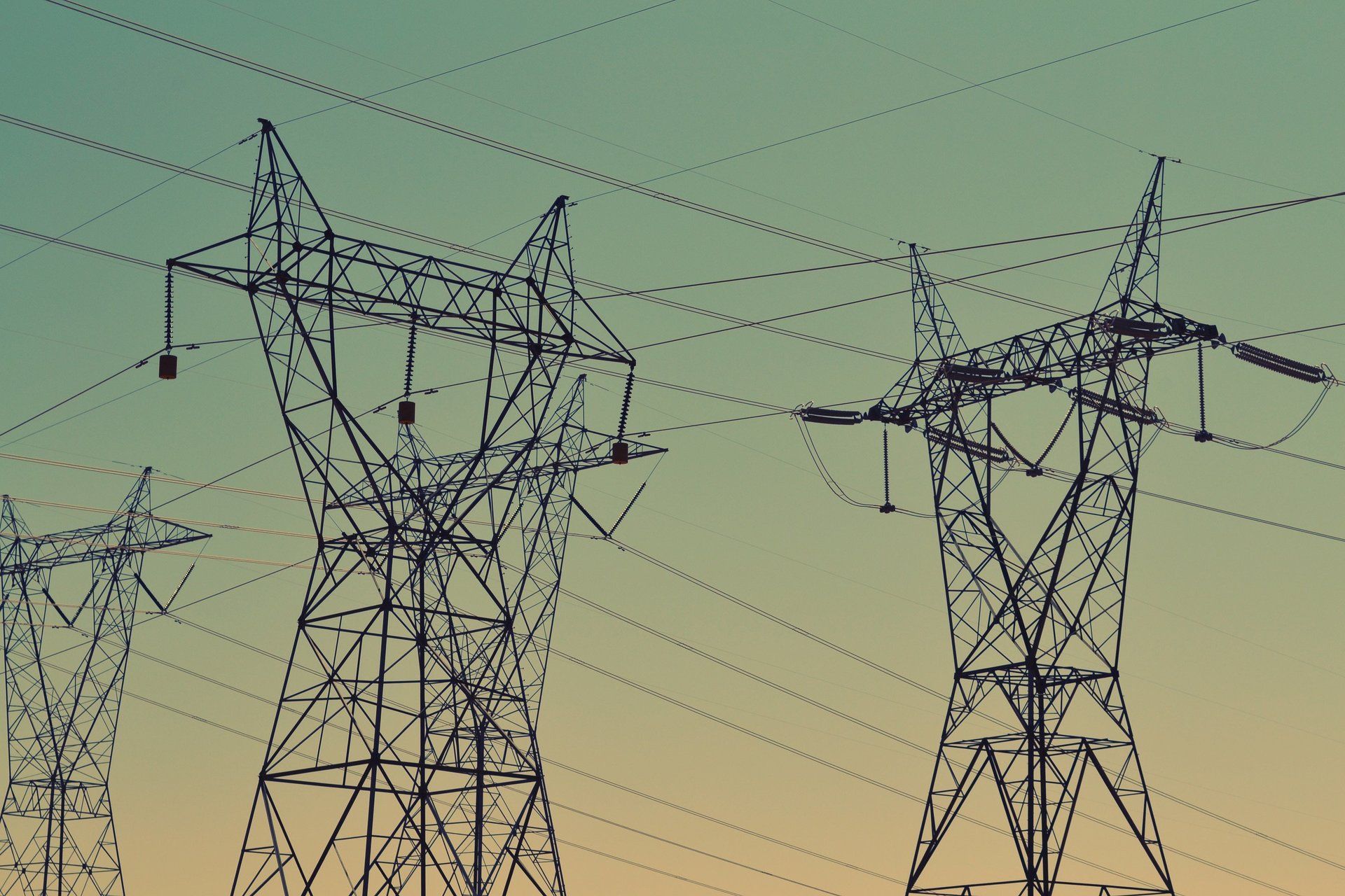 A row of power lines against a blue sky