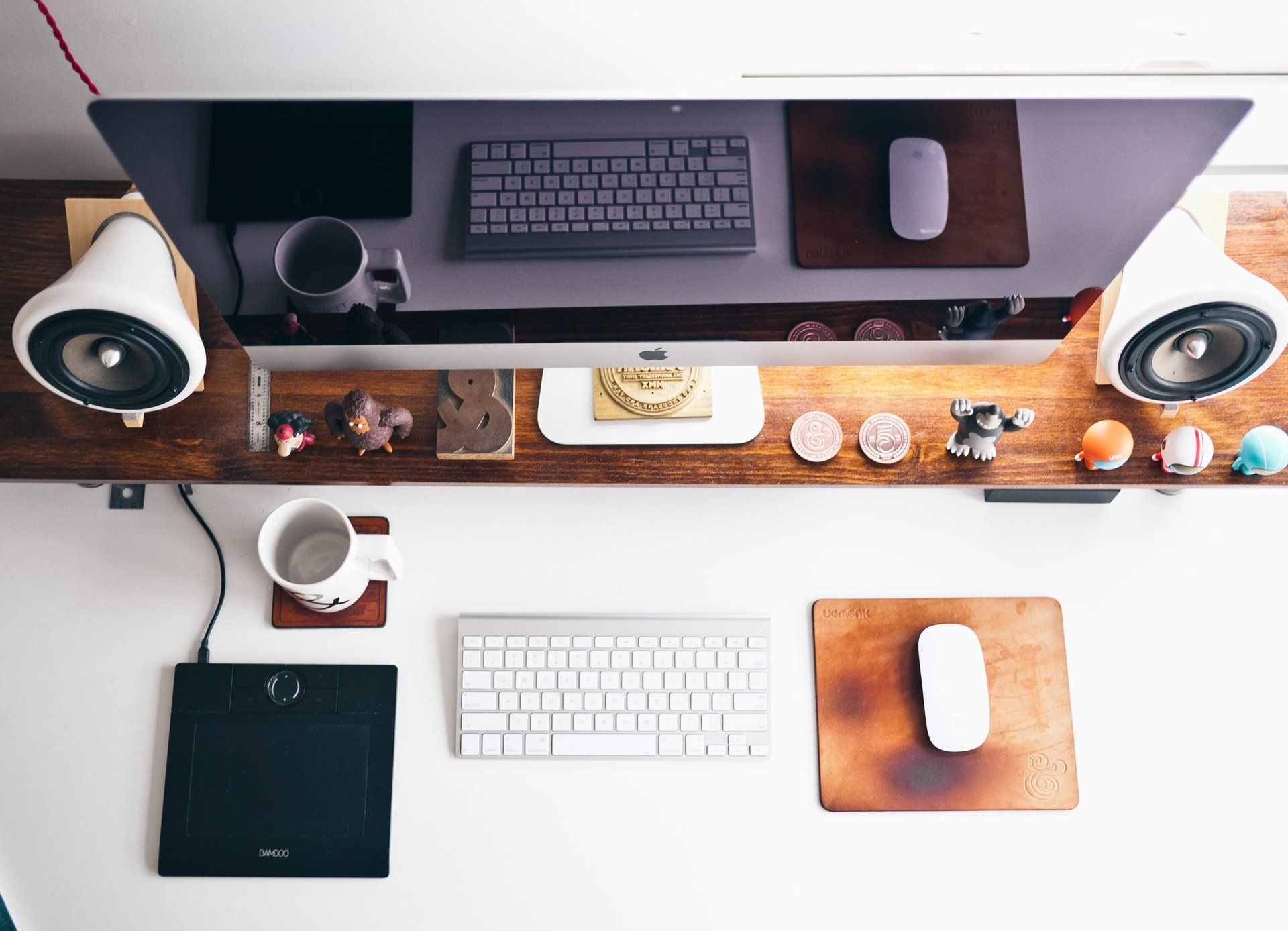 An aerial view of a desk with a computer keyboard and mouse