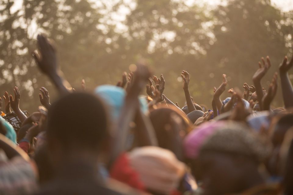 crowd with hands raised