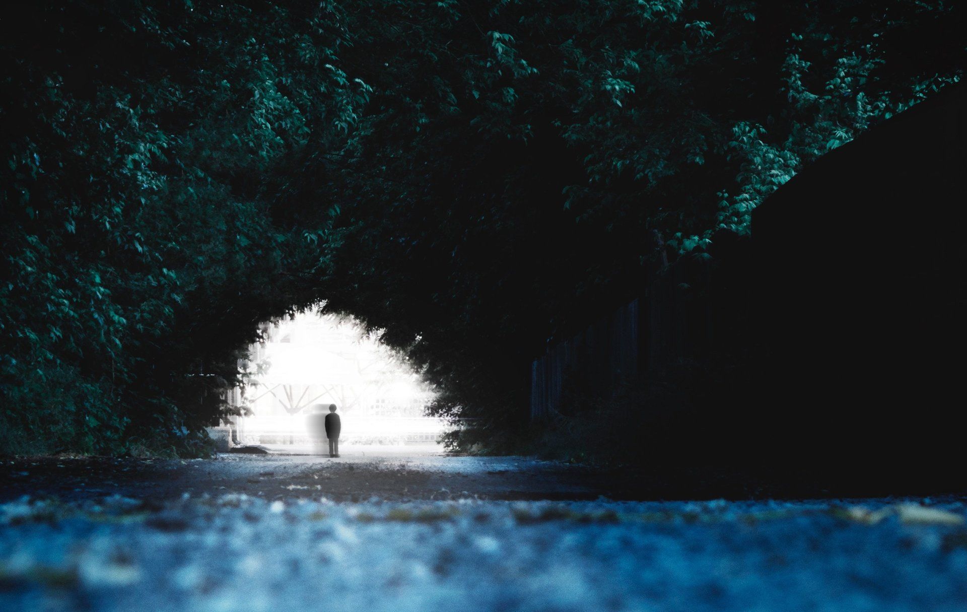 dark tunnel with fuzzy figure of person at far end