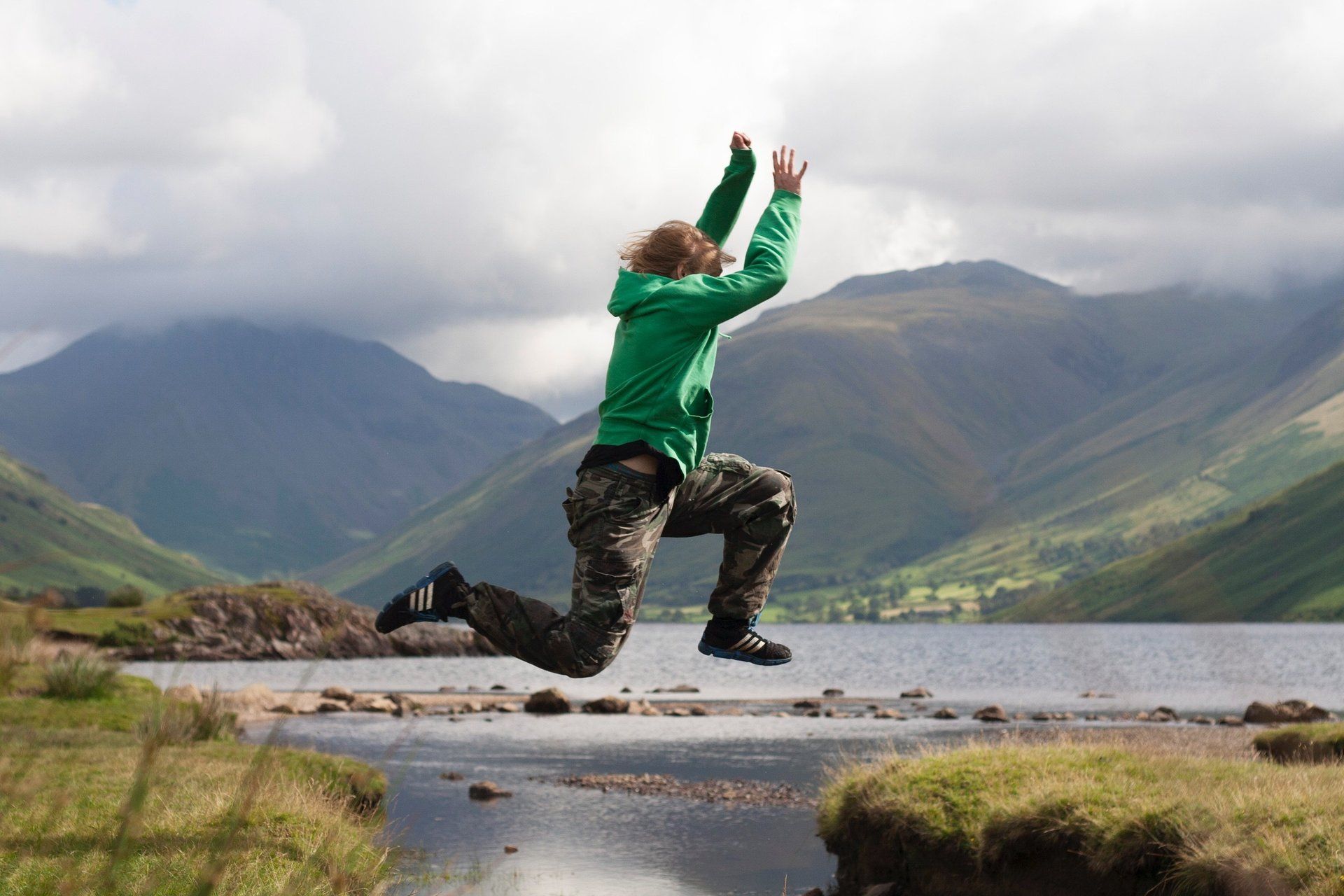teenager jumping stream