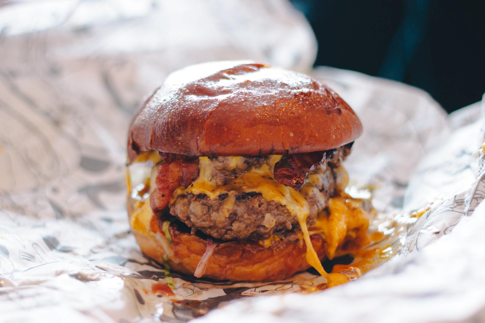 A close up of a hamburger on a piece of paper