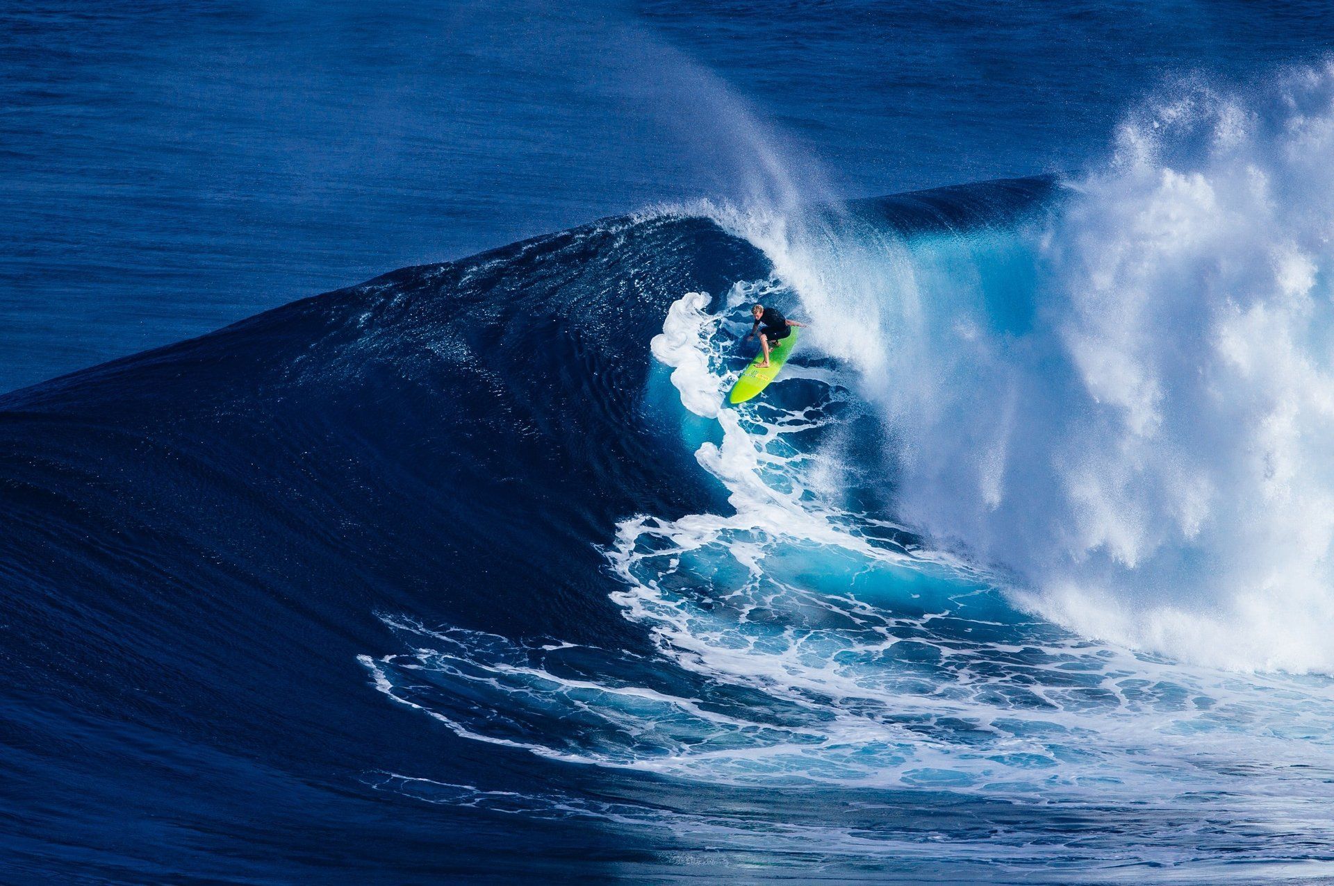 A person is riding a wave in the ocean.