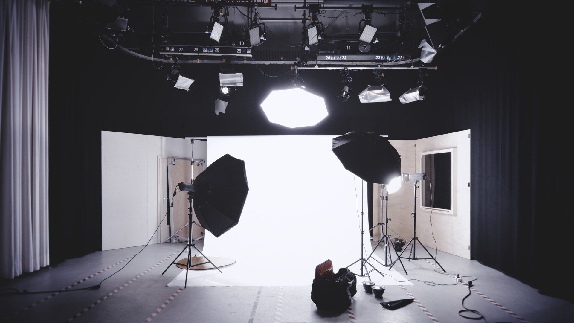 A black and white photo studio with a white backdrop