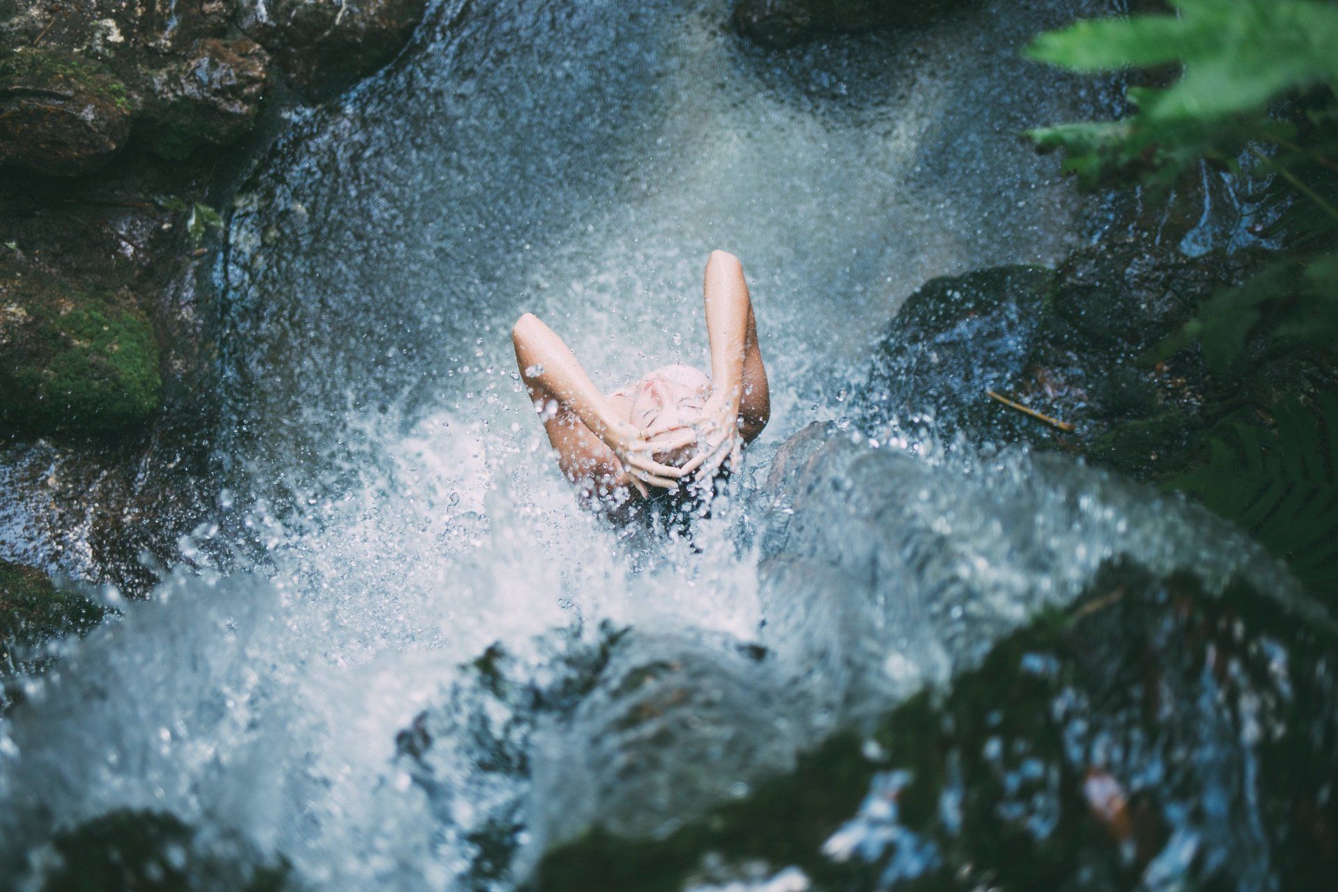 lady in waterfall cleaning washing