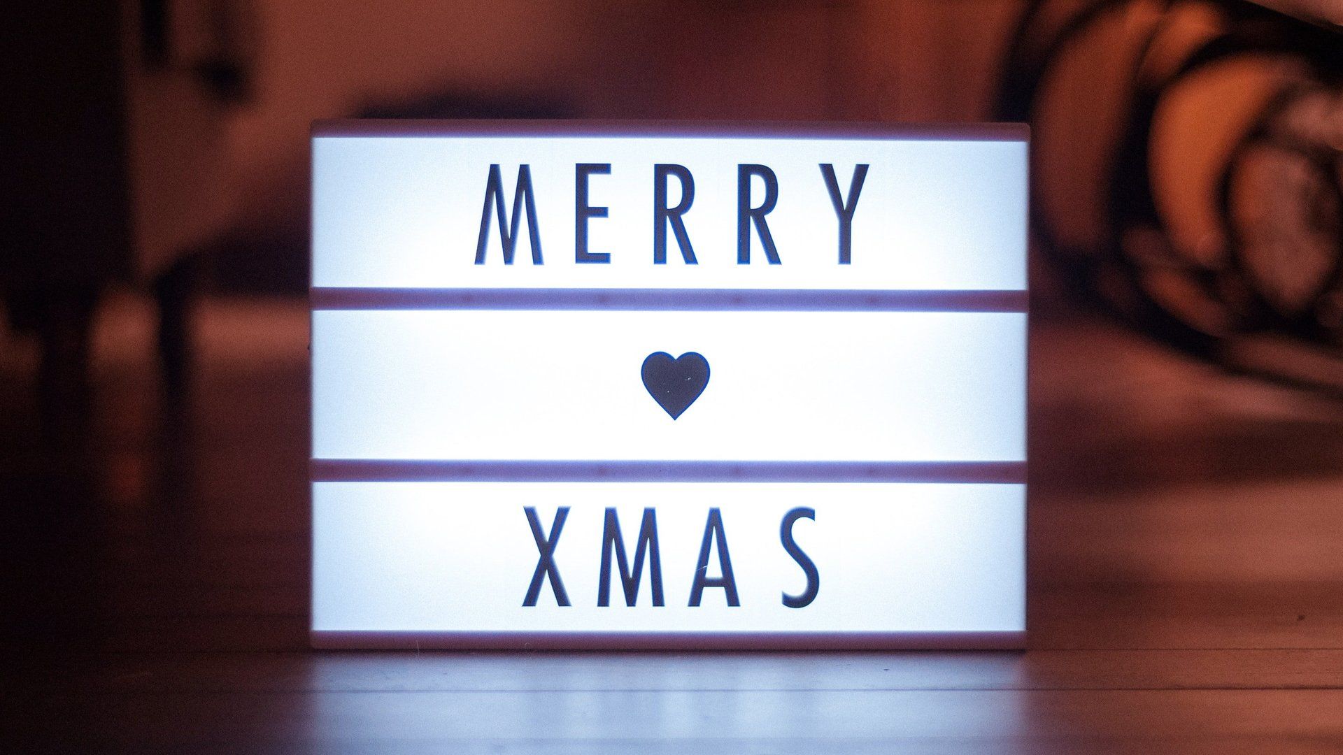 A light box that says merry xmas with a heart on it