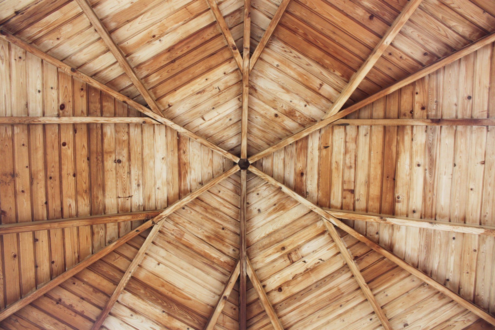 Looking up at the ceiling of a wooden building.