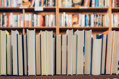 A row of books on a shelf in a library.