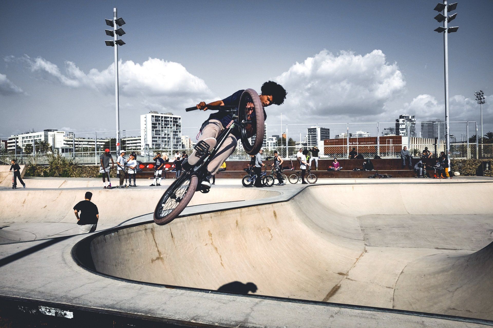 A man is doing a trick on a bike in a skate park.