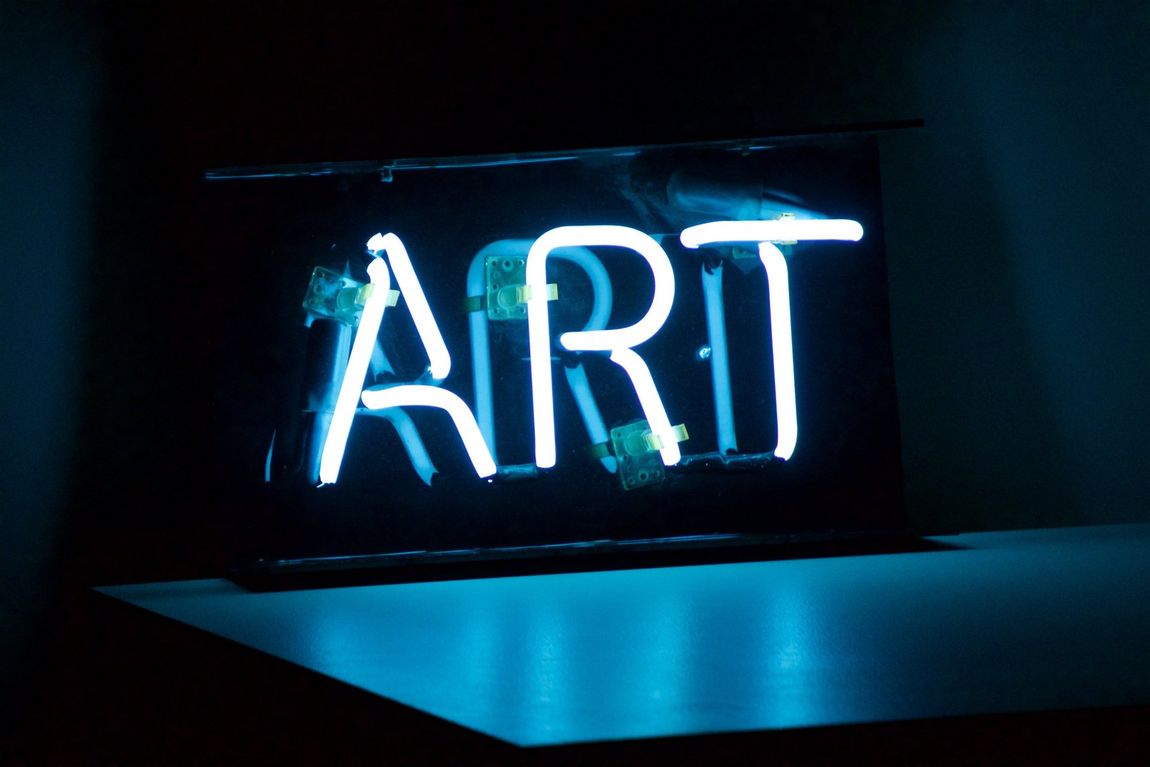 A neon sign with the word art on it