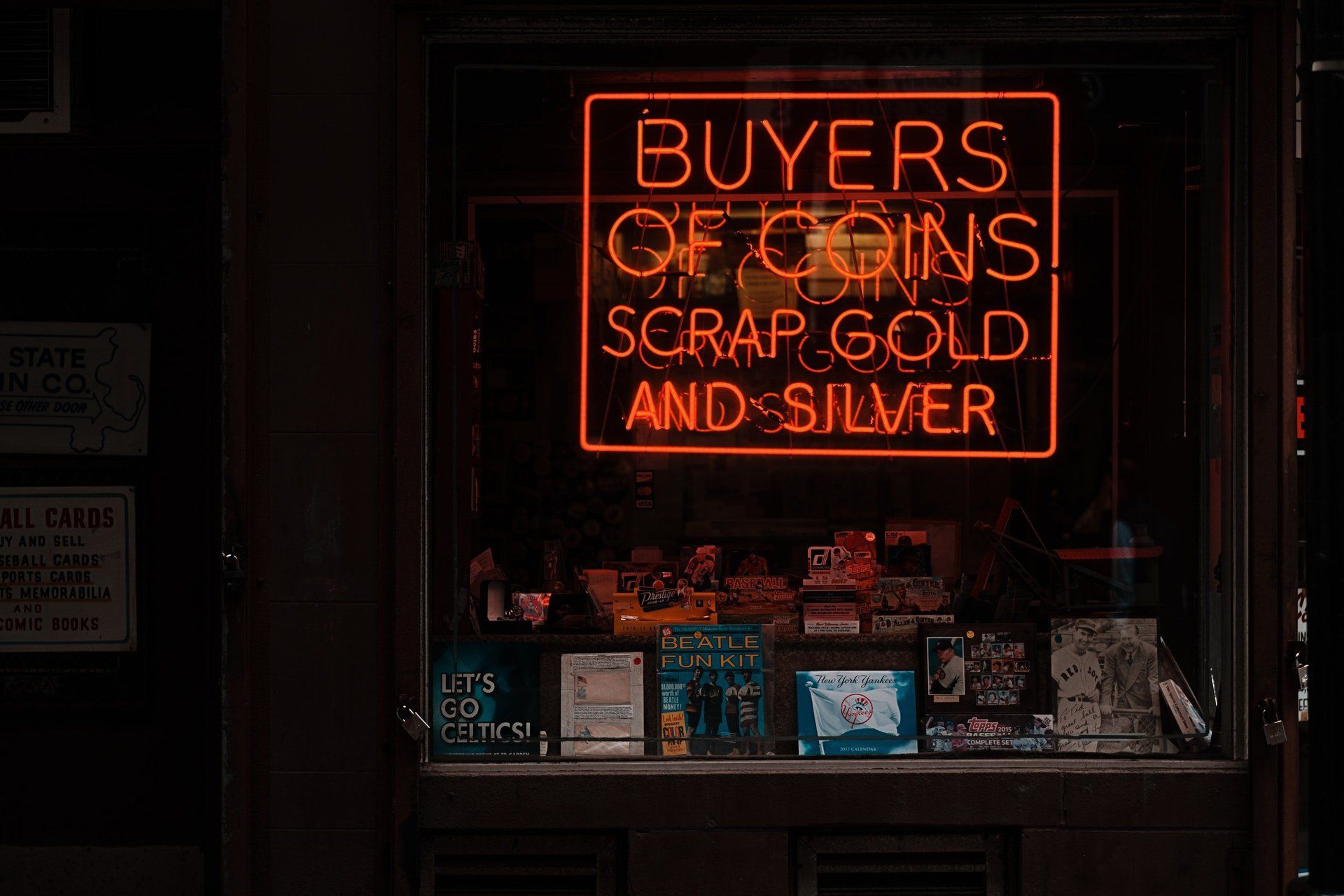 neon coin buyer sign in shop window