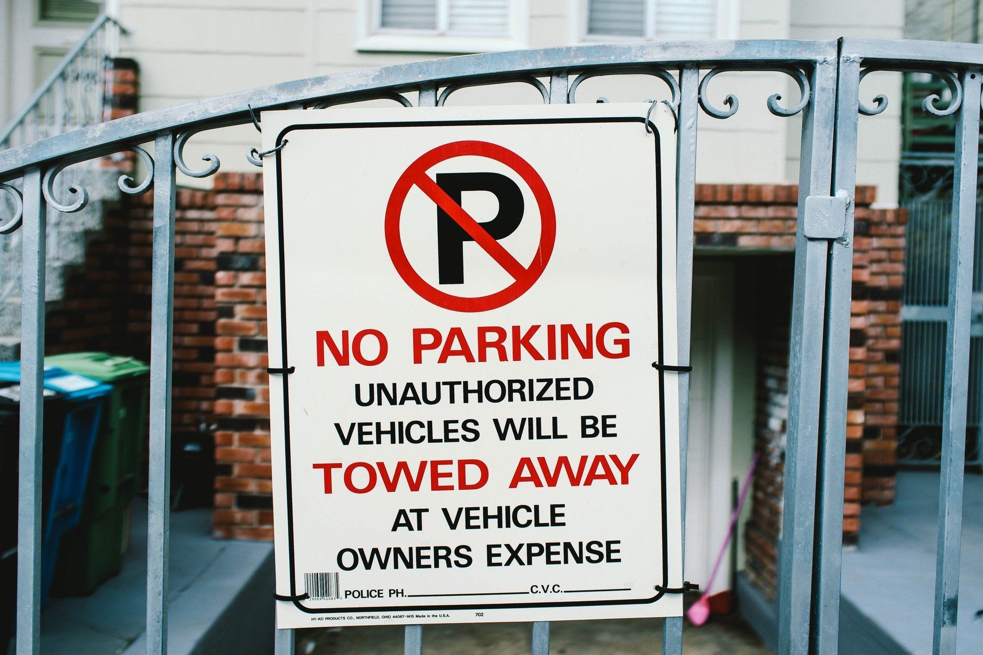 No parking sign on a gate; text: 