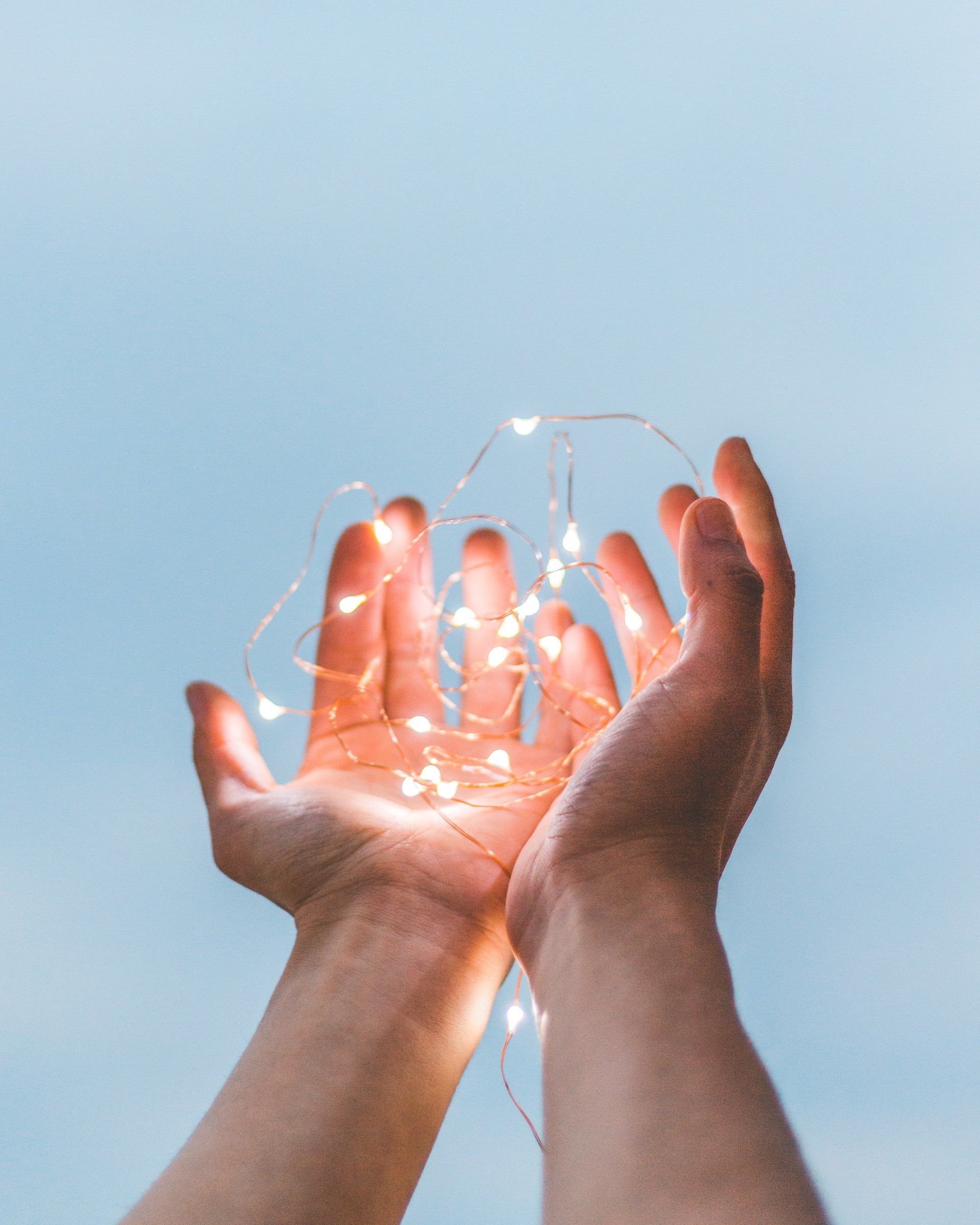 Hands holding lights of Hope