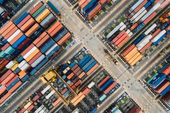 An aerial view of a warehouse filled with lots of shipping containers.