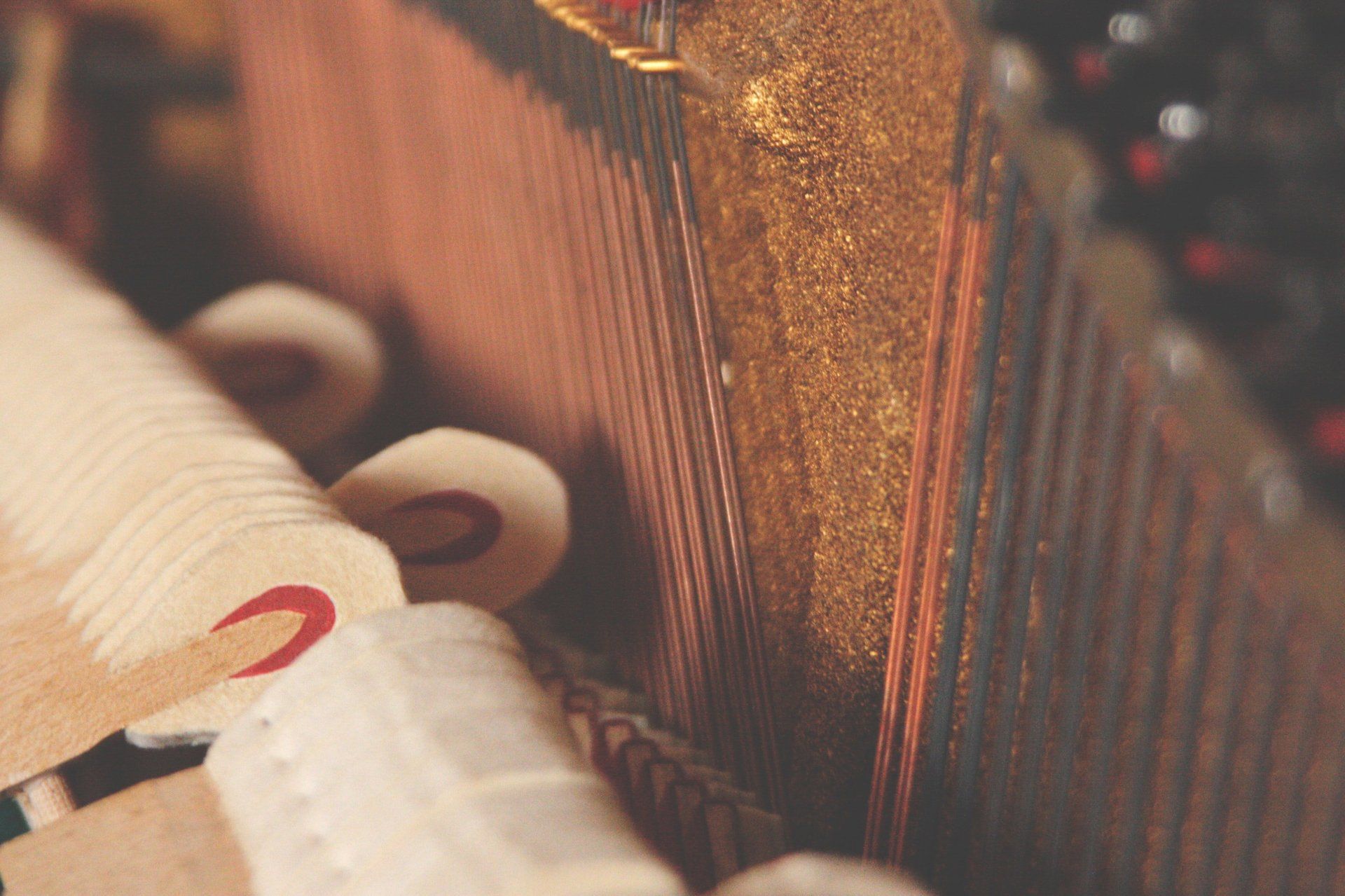 A close up of a piano with a person playing it.