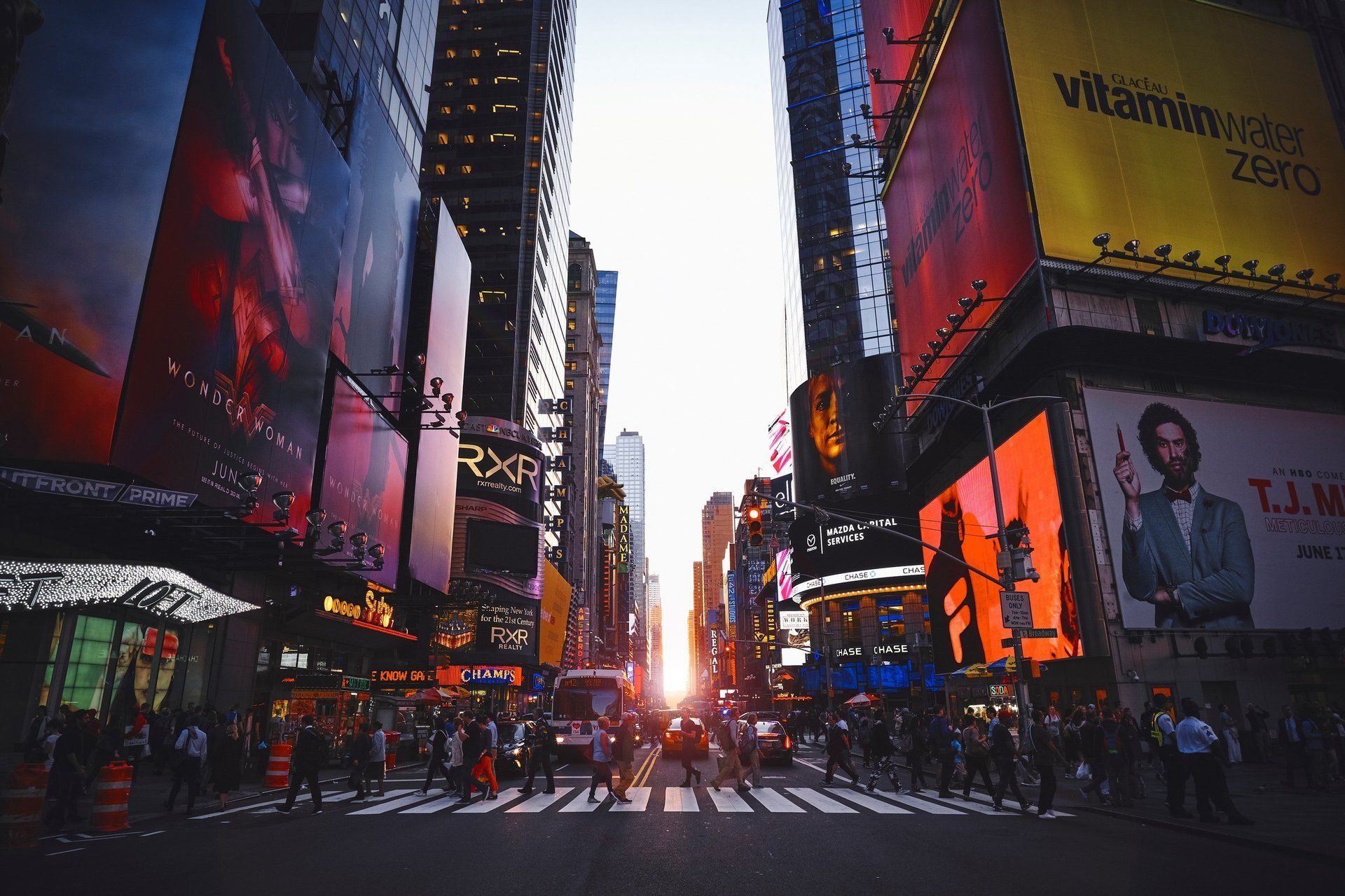 A busy city street with a billboard for vitaminwater