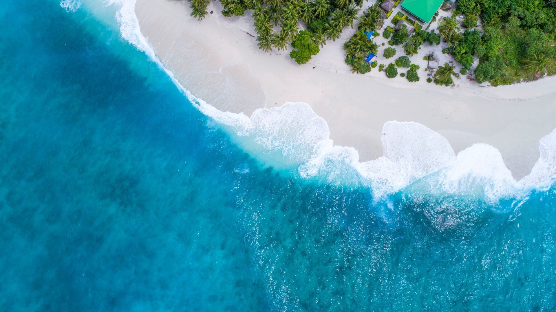 An aerial view of a small island in the middle of the ocean.