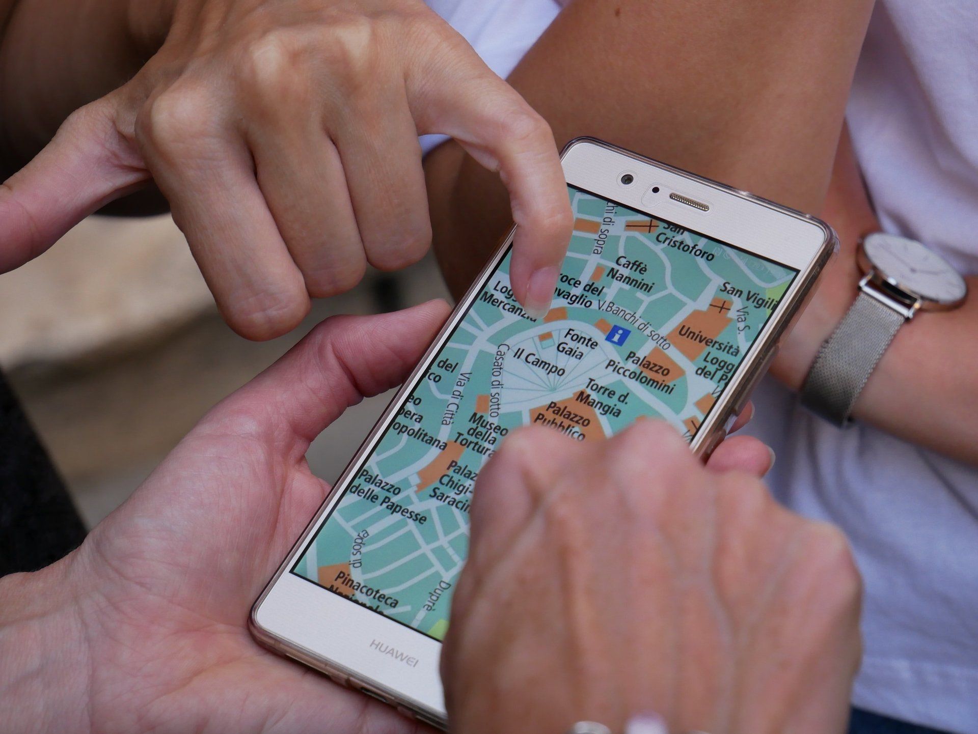 individual holding cell phone looking at map